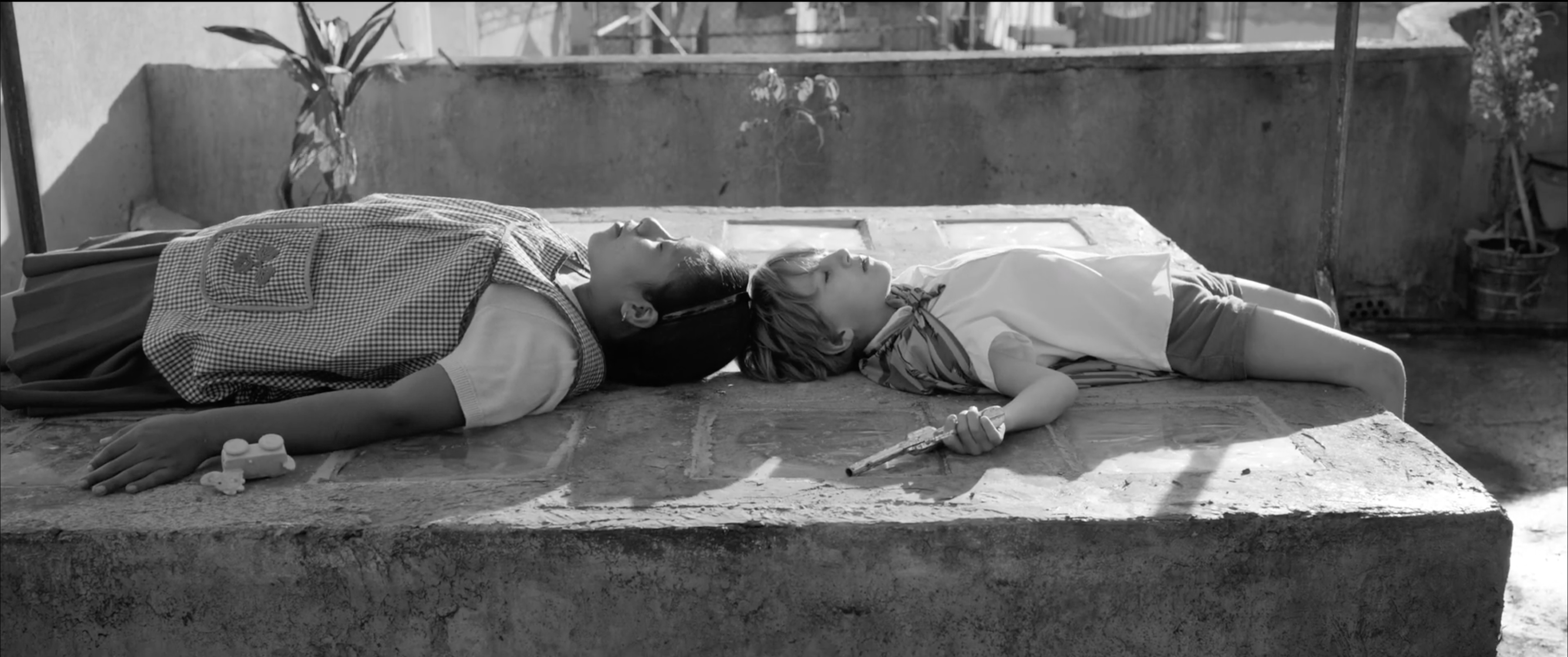 Cleo wearing her work apron while resting with a child