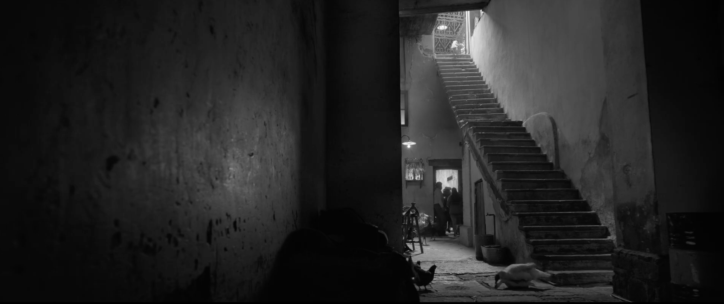 Dark interior staircase lit by a small practical lamp