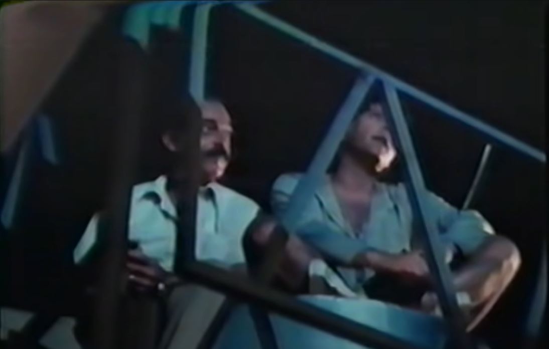 Julio and Bobby obscured under a bridge