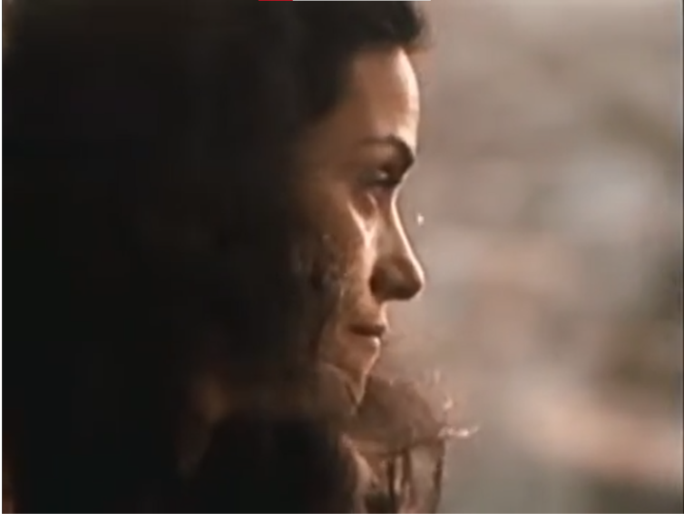 Close shot of Lina, who is looking away from the camera