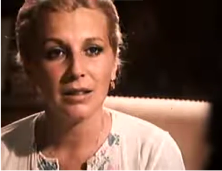 Close shot of Marian, who is frowning