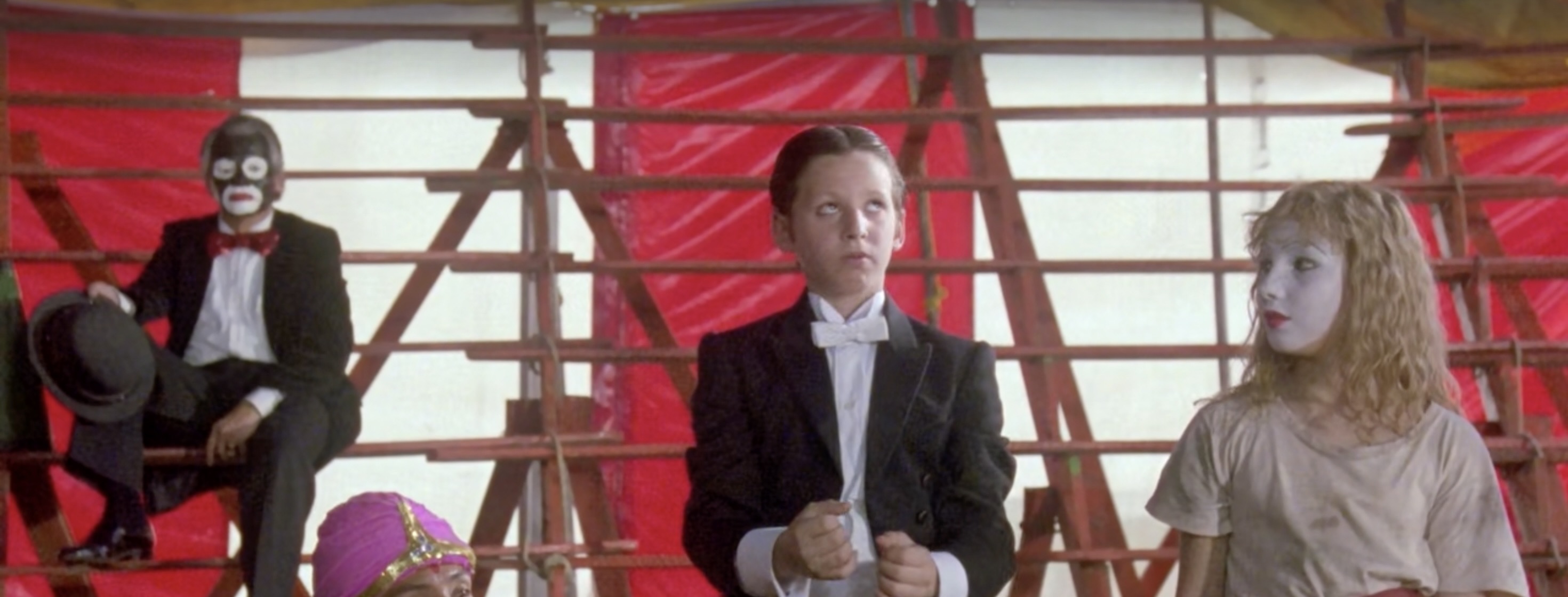 The circus tent is a centerpiece of Fénix’s childhood, filled with oversized props, strange beasts, and hyped-up color. A frame of the circus performance captures the intermingling of awe and ghoulishness typical of his childhood world.