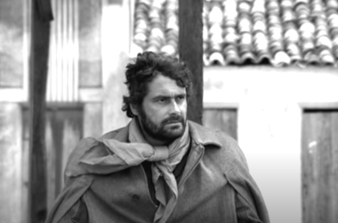 Antonio das Mortes has a neat and well-groomed appearance, indicative of his relative wealth and privilege compared to Manuel and other characters.