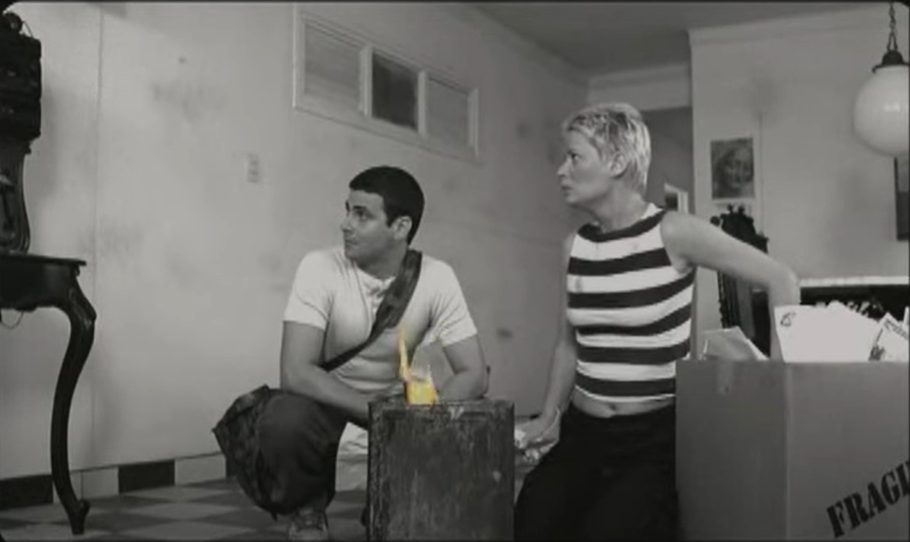 César and Carla in her apartment trying to burn the letters.