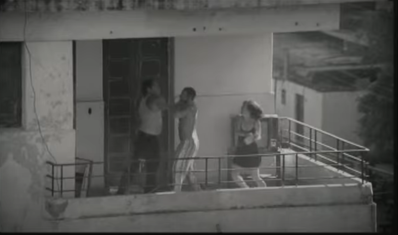 A man strangles the cheating partner of his girlfriend. The girlfriend tries to attack the man with an iron.