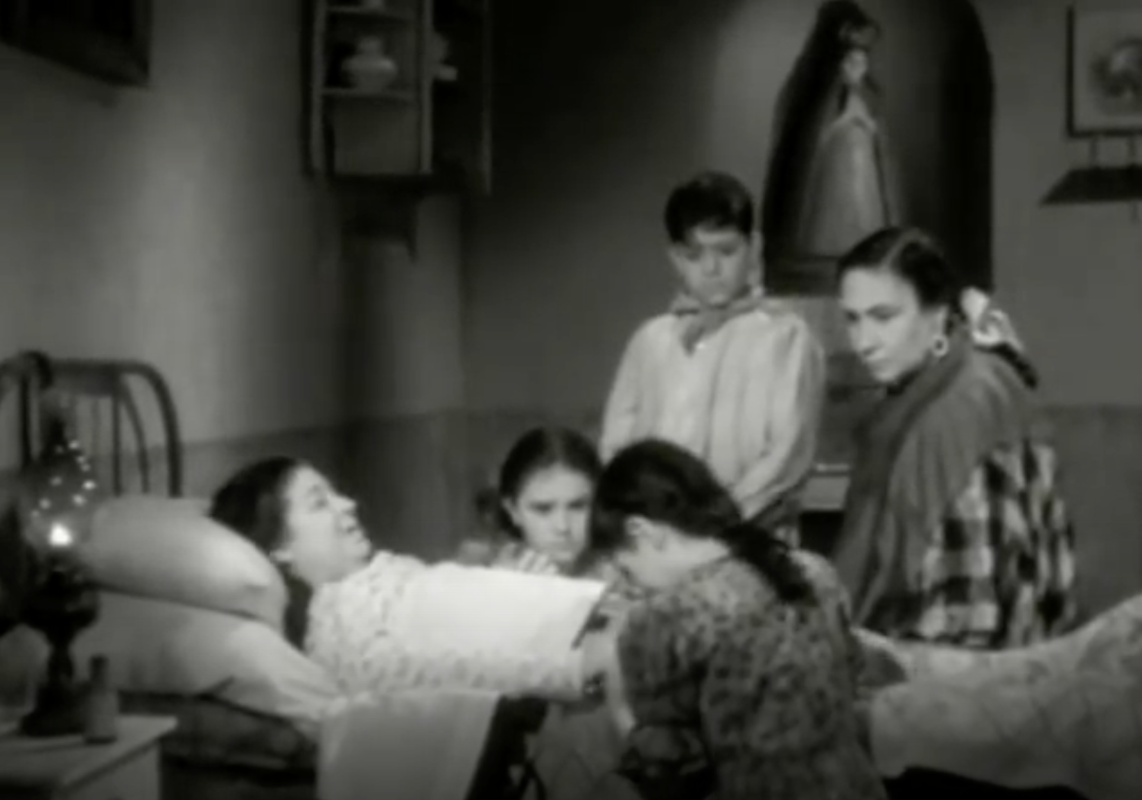 (00:08:46). This still represents the lack of love for Cruz by Ángela. The way the actress portraying Ángela has a good way of showing her disdain for taking care of an orphan. Her face seems to lack any sort of expression as she looks at the crying child. This still in particular is able to contrast the love and warmth coming off the mother with the stern gaze of Ángela.