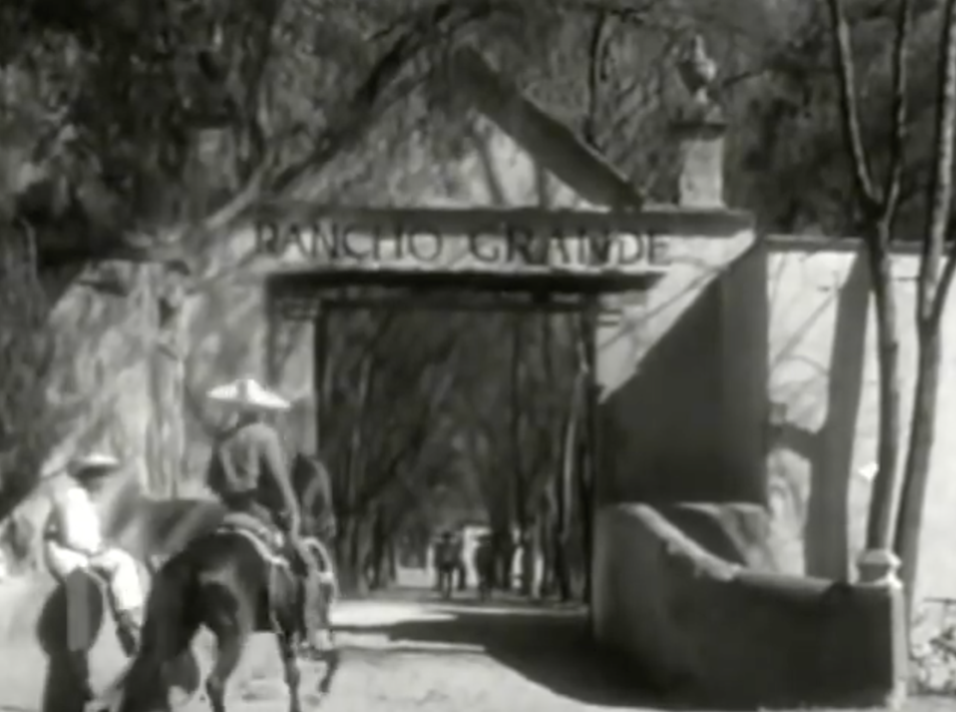 (00:02:14-00:03:30). This still is at the beginning of the film and is supposed to show the entrance to “el Rancho Grande”, where the film takes place. Everything about this image is very perfect and organized. It seems as though the entrance is perfectly centered with even rows of trees on either side of the trail.