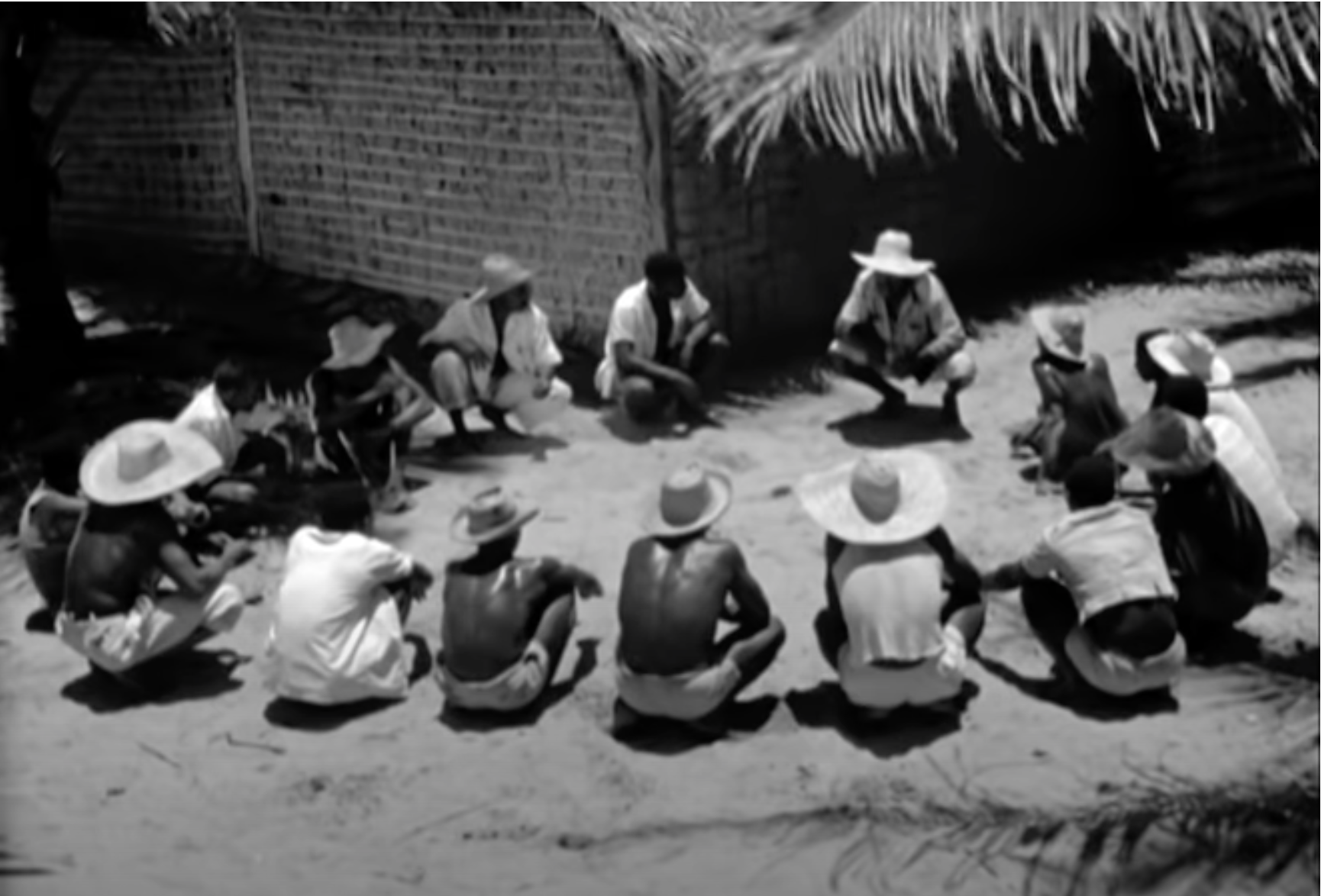 Men sitting in a circle.