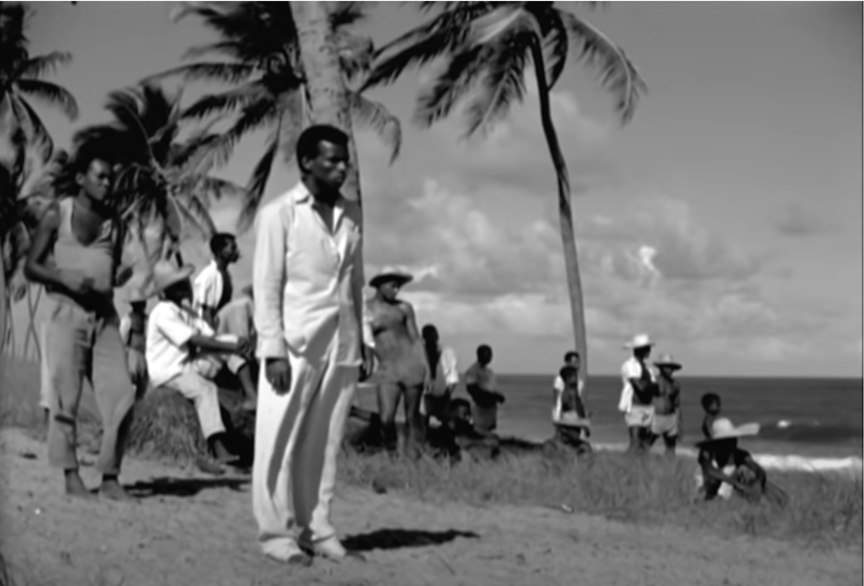Firmino standing in front of the fishermen, trying to get them to rebel with him.
