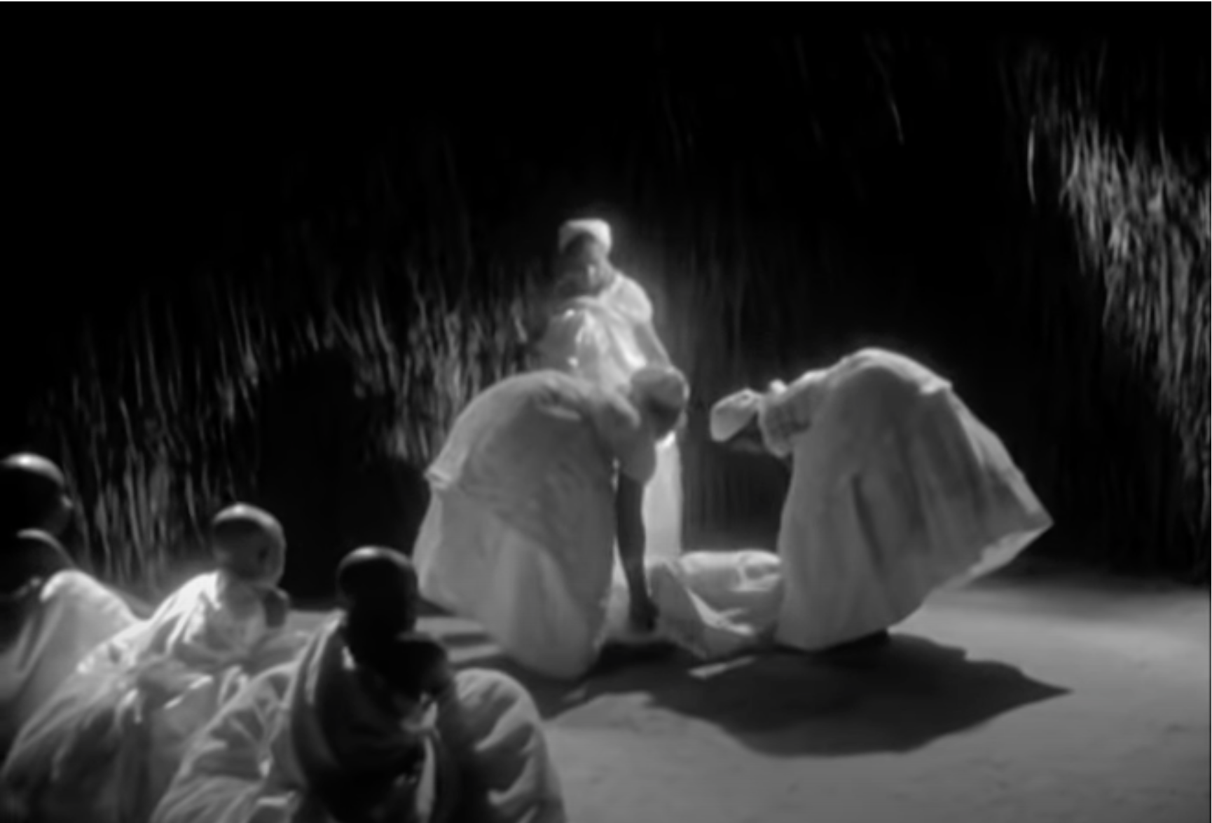 The women of the village picking up Naína after she fainted.