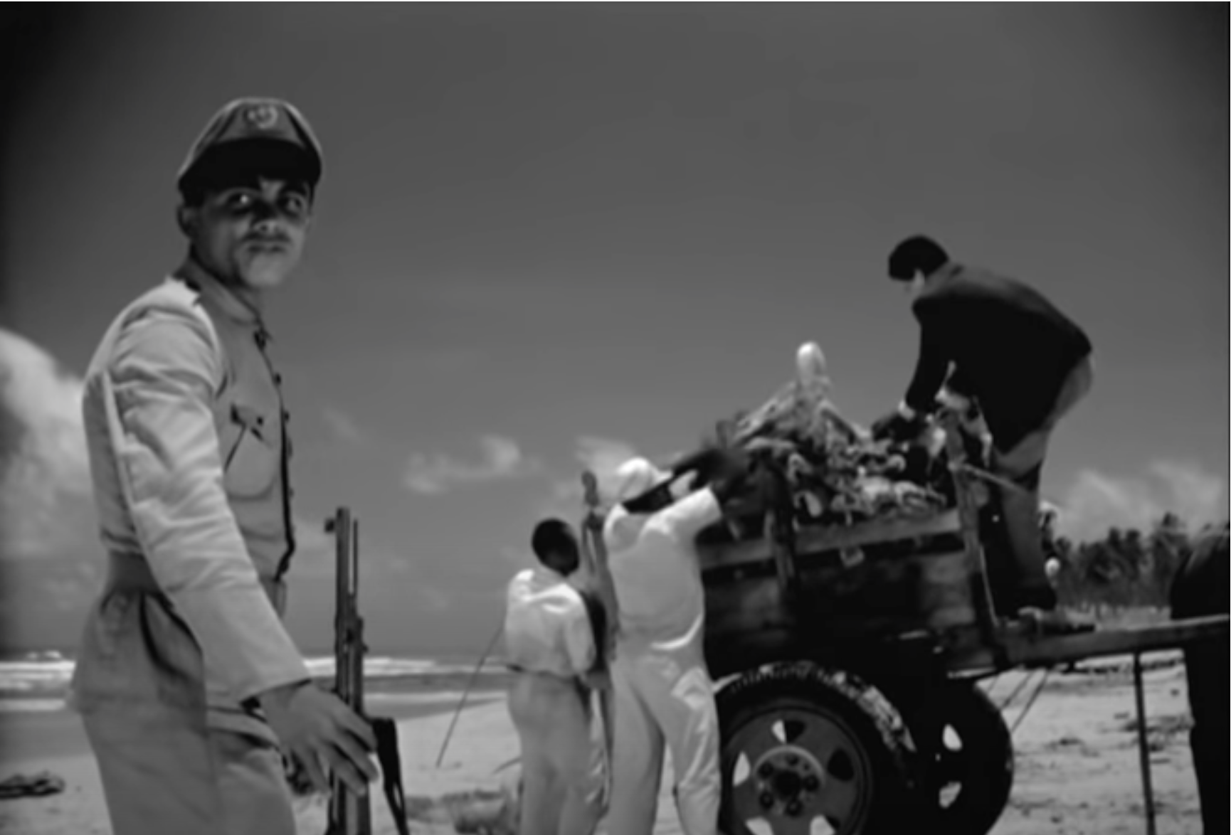 The policeman watching the people of Buraquinho.