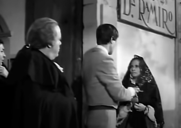 Don Ramiro watches as Macario hands the poor customer her money back.