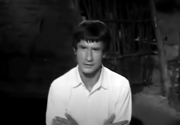 Macario sits at the dinner table wearing a clean, white shirt.