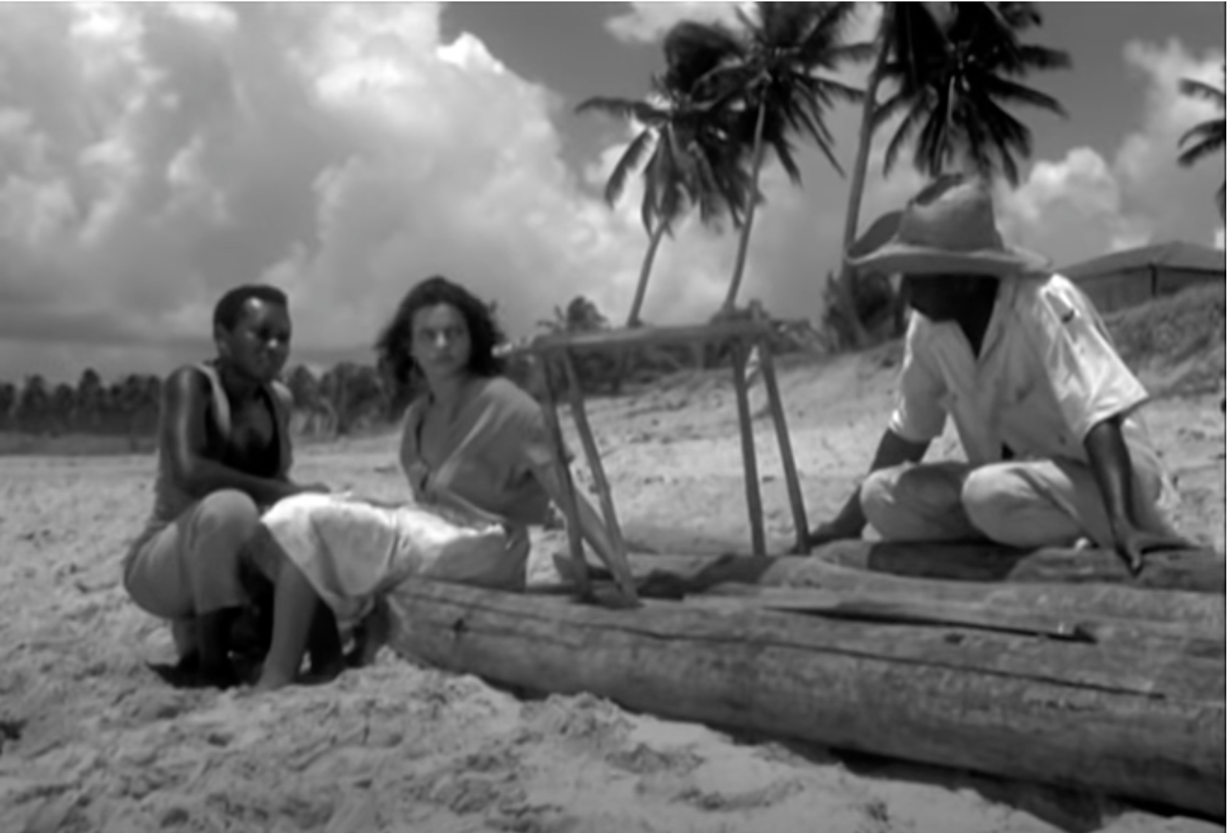 Naína sitting on a raft with two men.