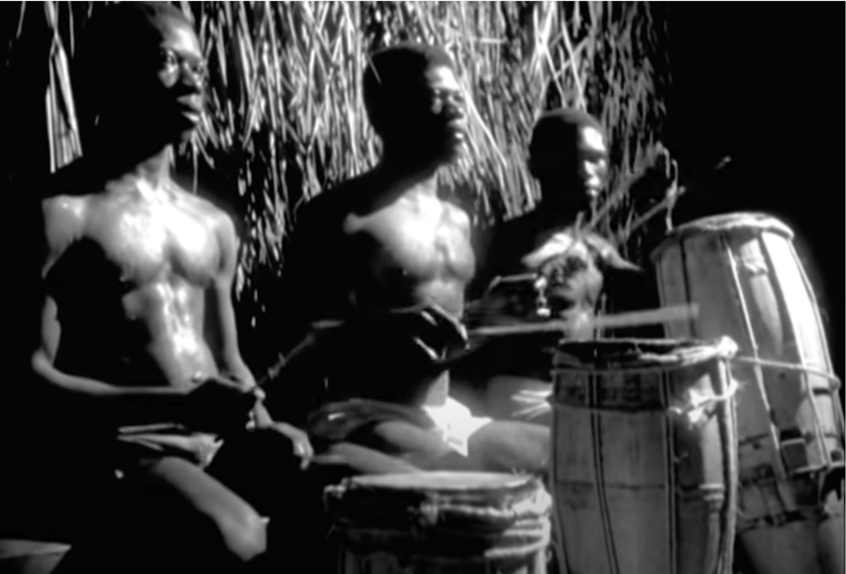 Men of the village drumming in the old woman's hut.
