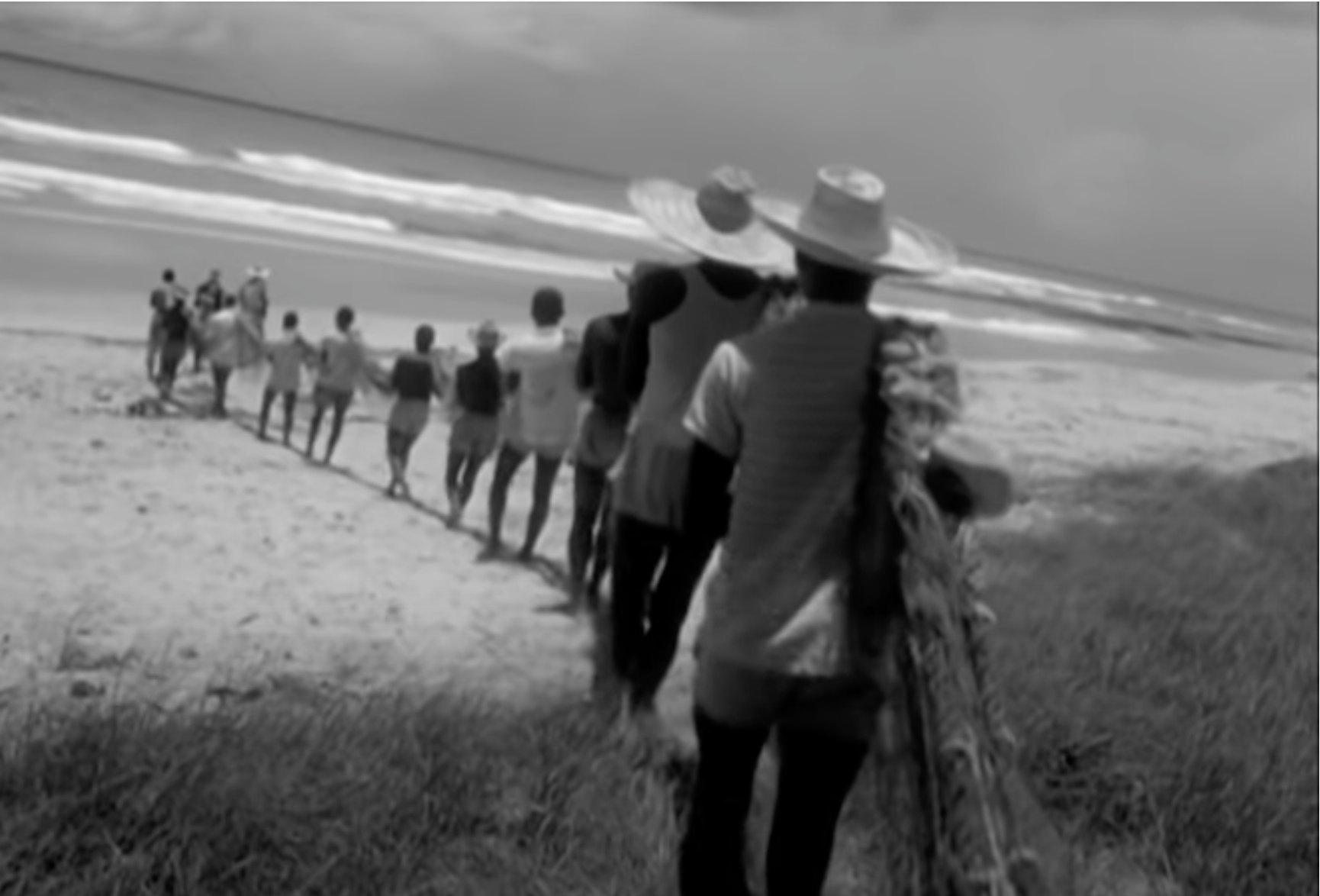Men carrying the net into the water.
