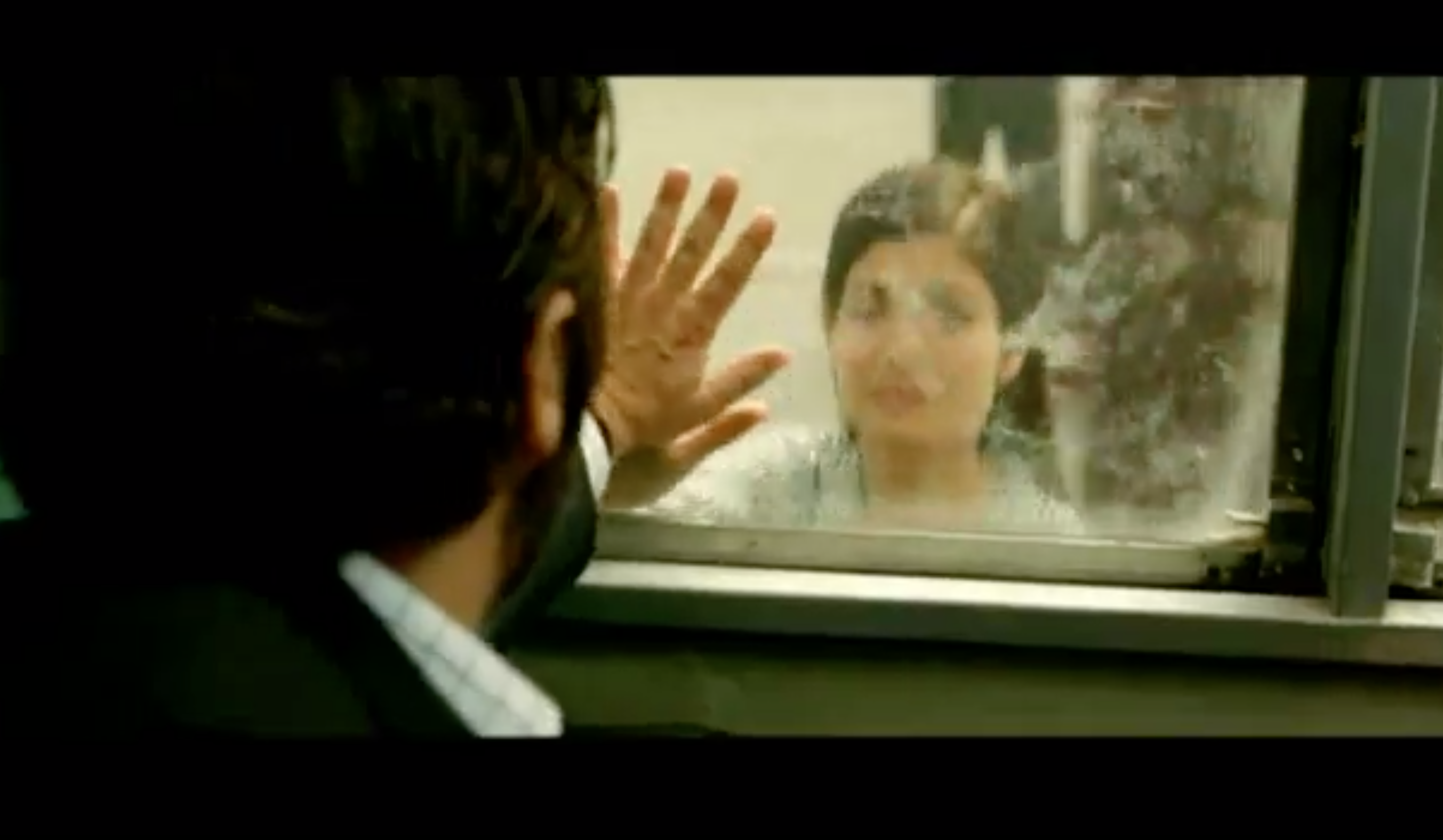 We see Espósito and Irene meeting hands on two different sides of the train window.