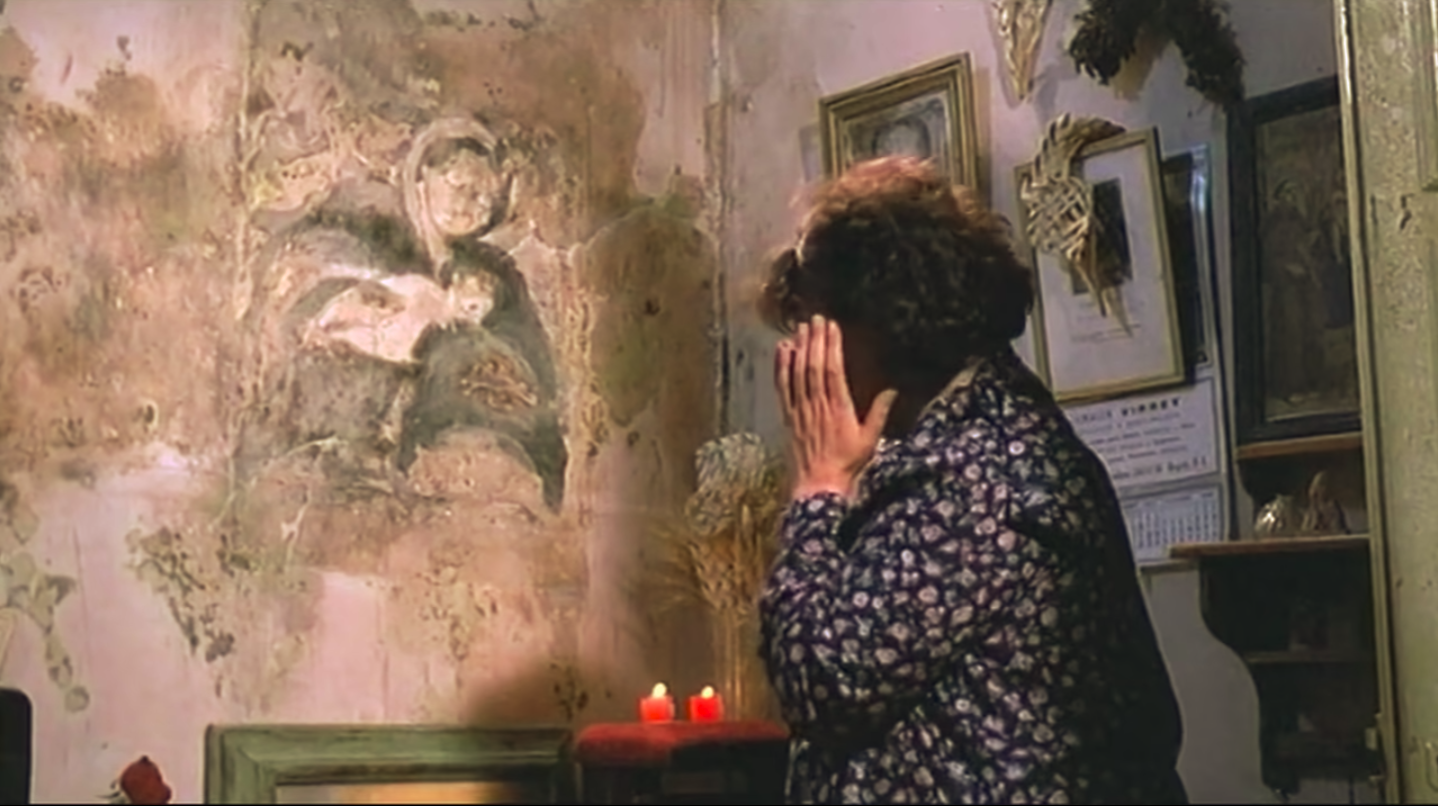 A woman prays before the miraculous stain of Virgin Mary.