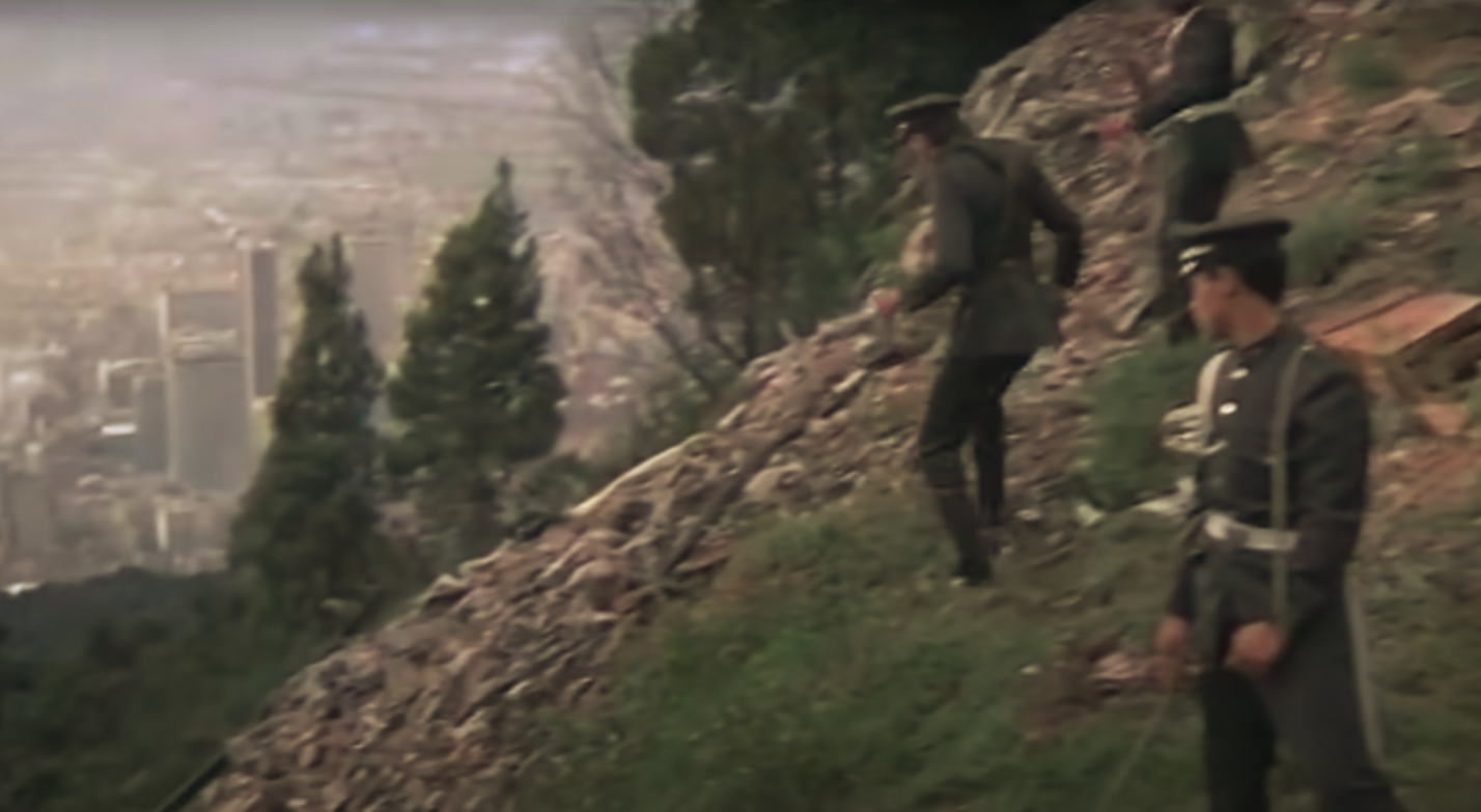 A police officer is seen running from an ambulance (during pan)