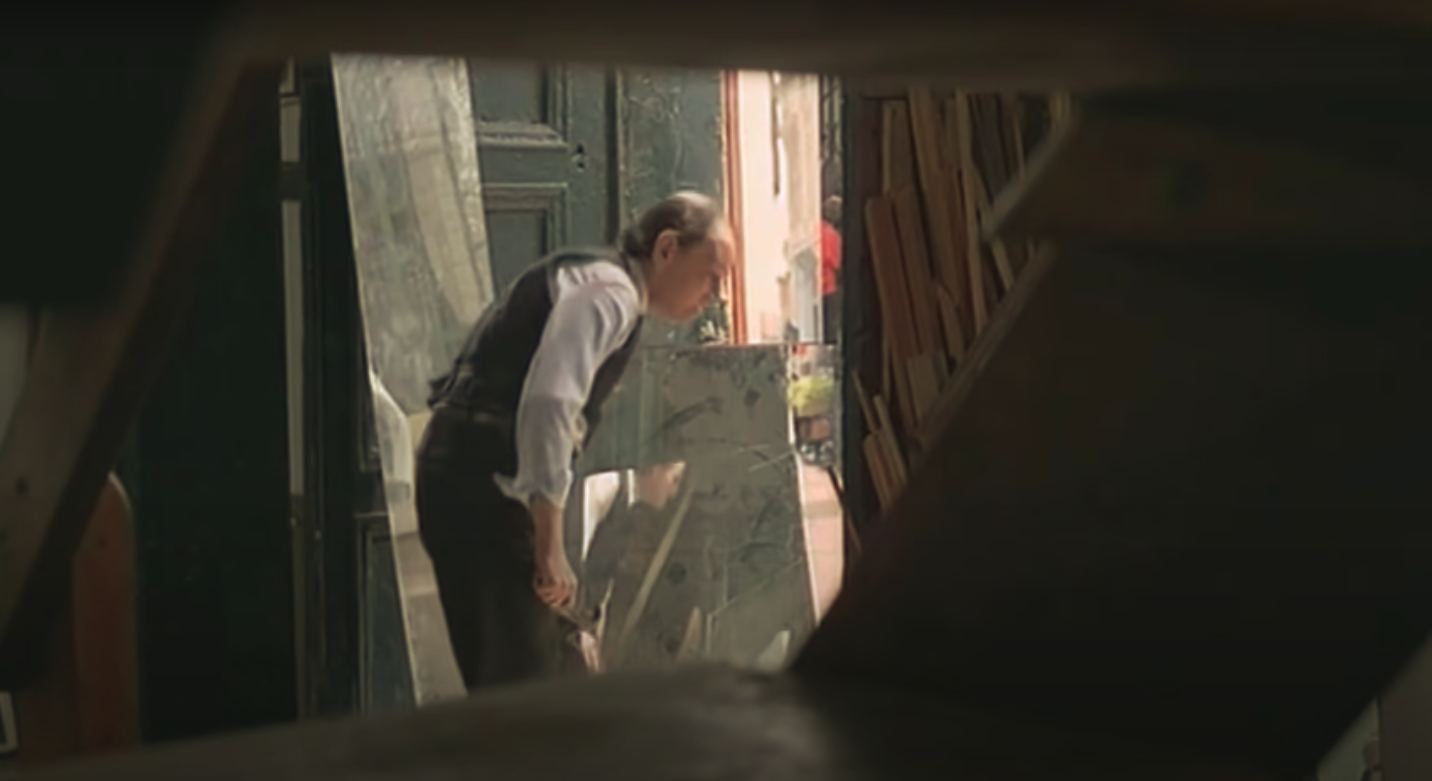 A man is filmed through a small crack and presumed to be watched by Jacinto.