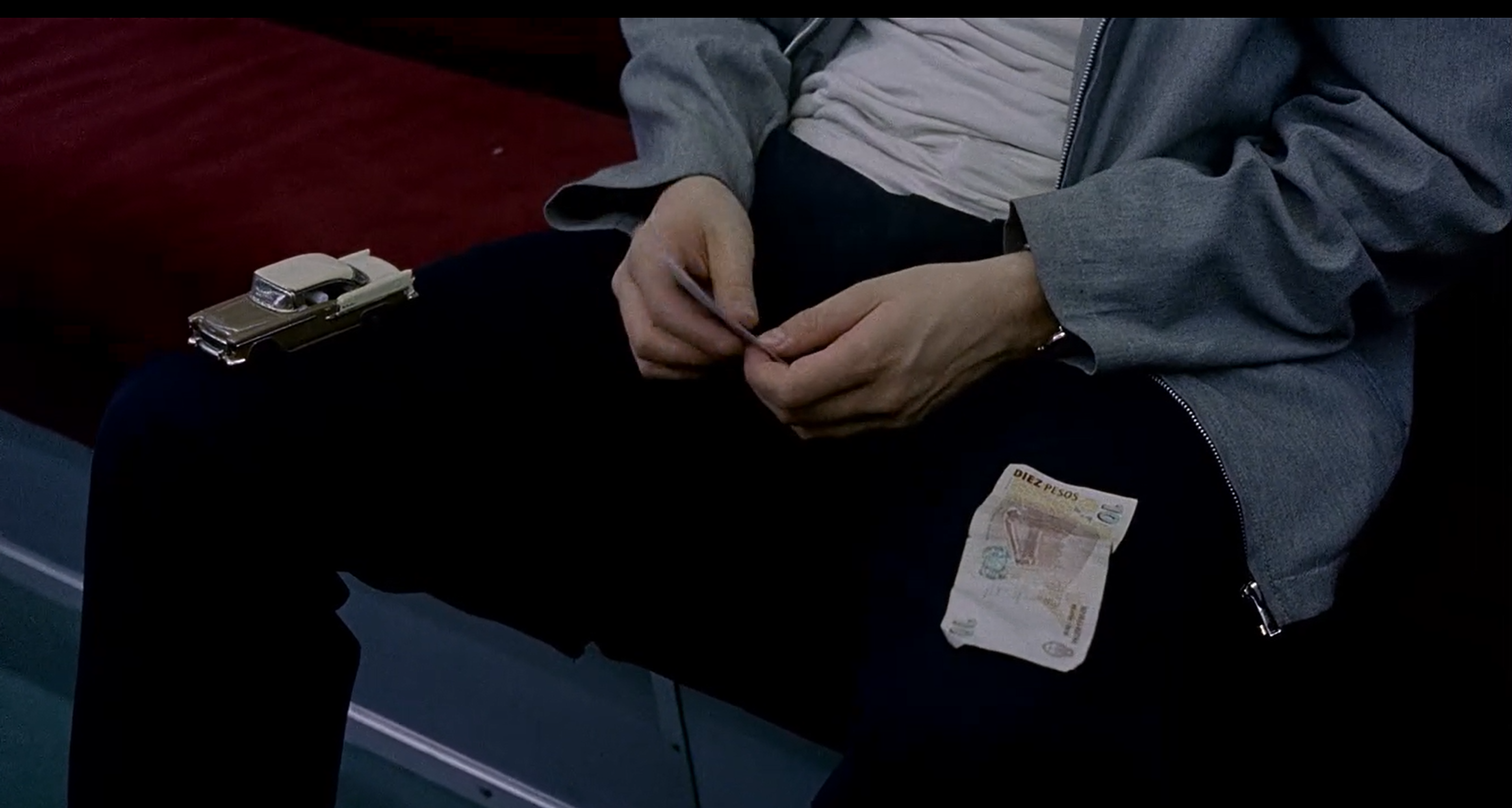 Juan giving the boy on the subway a choice between a toy car and money.