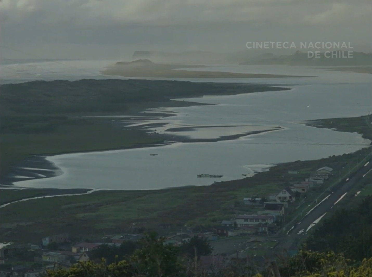 Aerial view of the village where the film takes place. The ocean and houses next to it can be seen. 