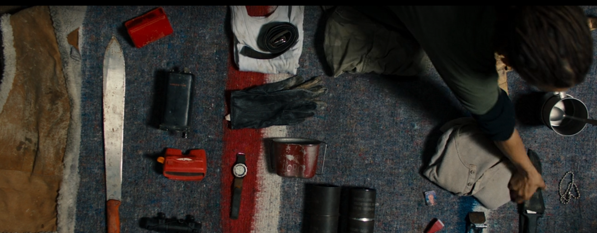 Props: weapons and belonging on a blanket.
