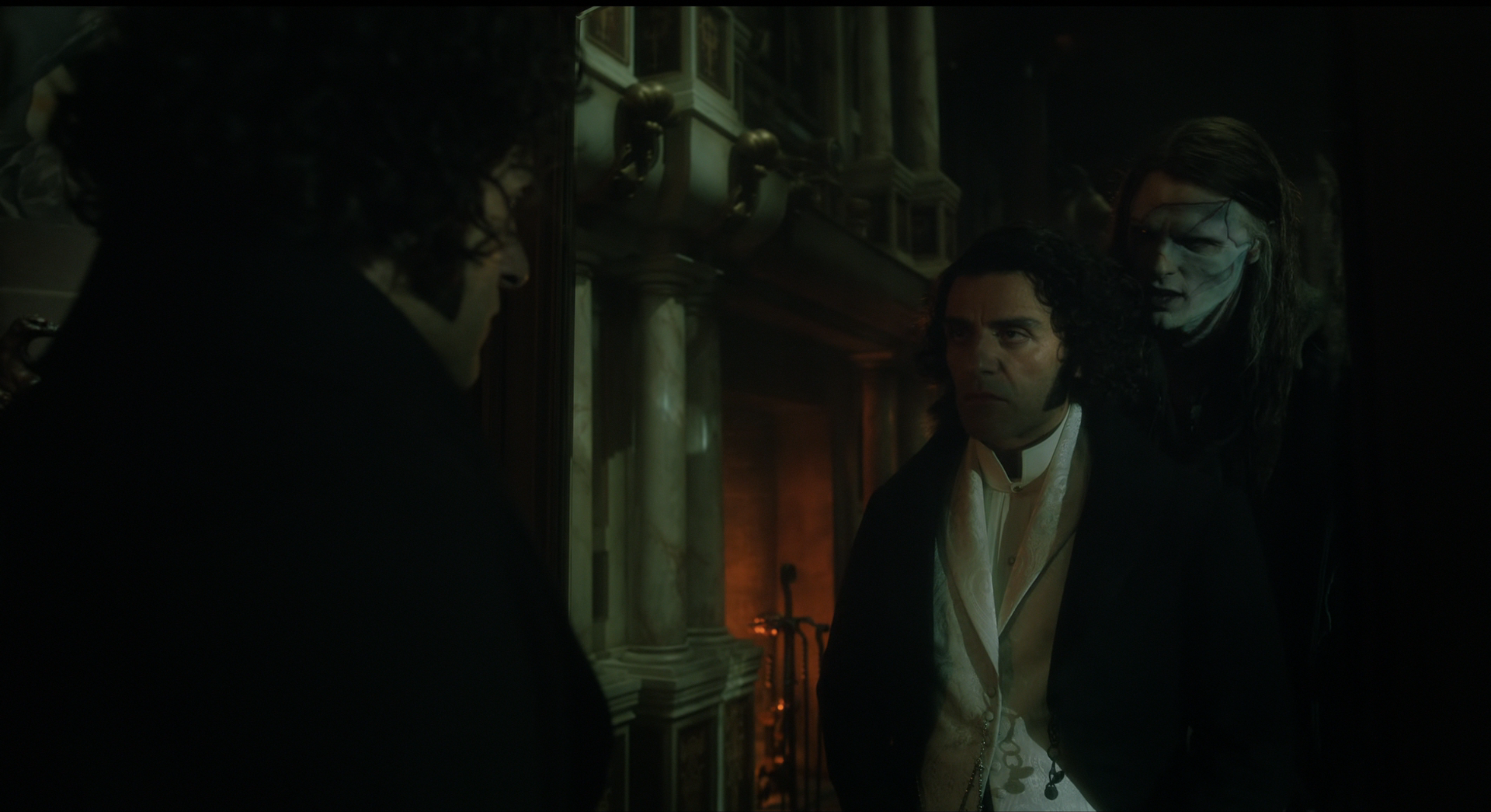 The creature looms over Victor's shoulder after sneaking into his room, confronting him about his creation.