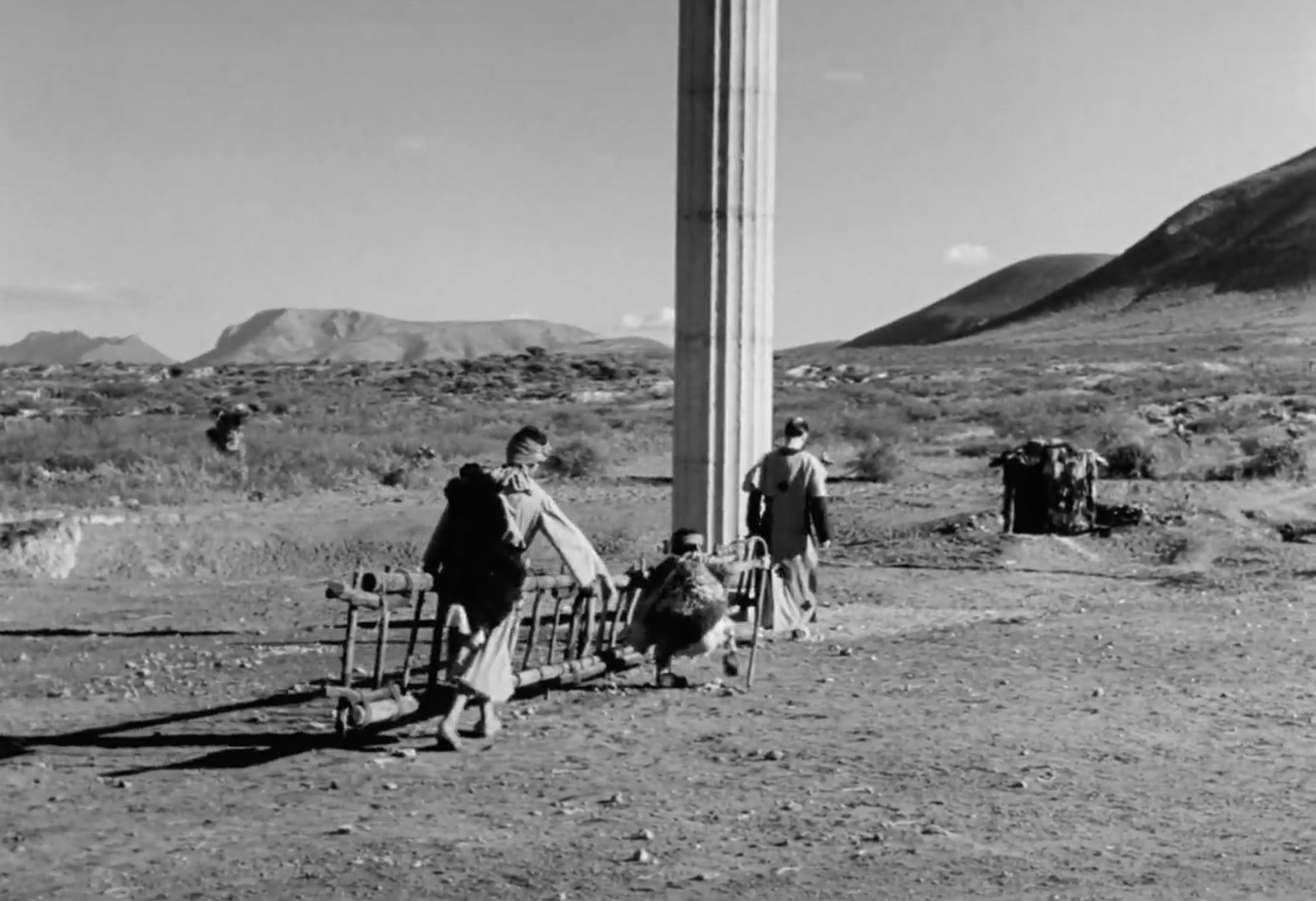 Villagers/church members carry ladder to reach Simón.