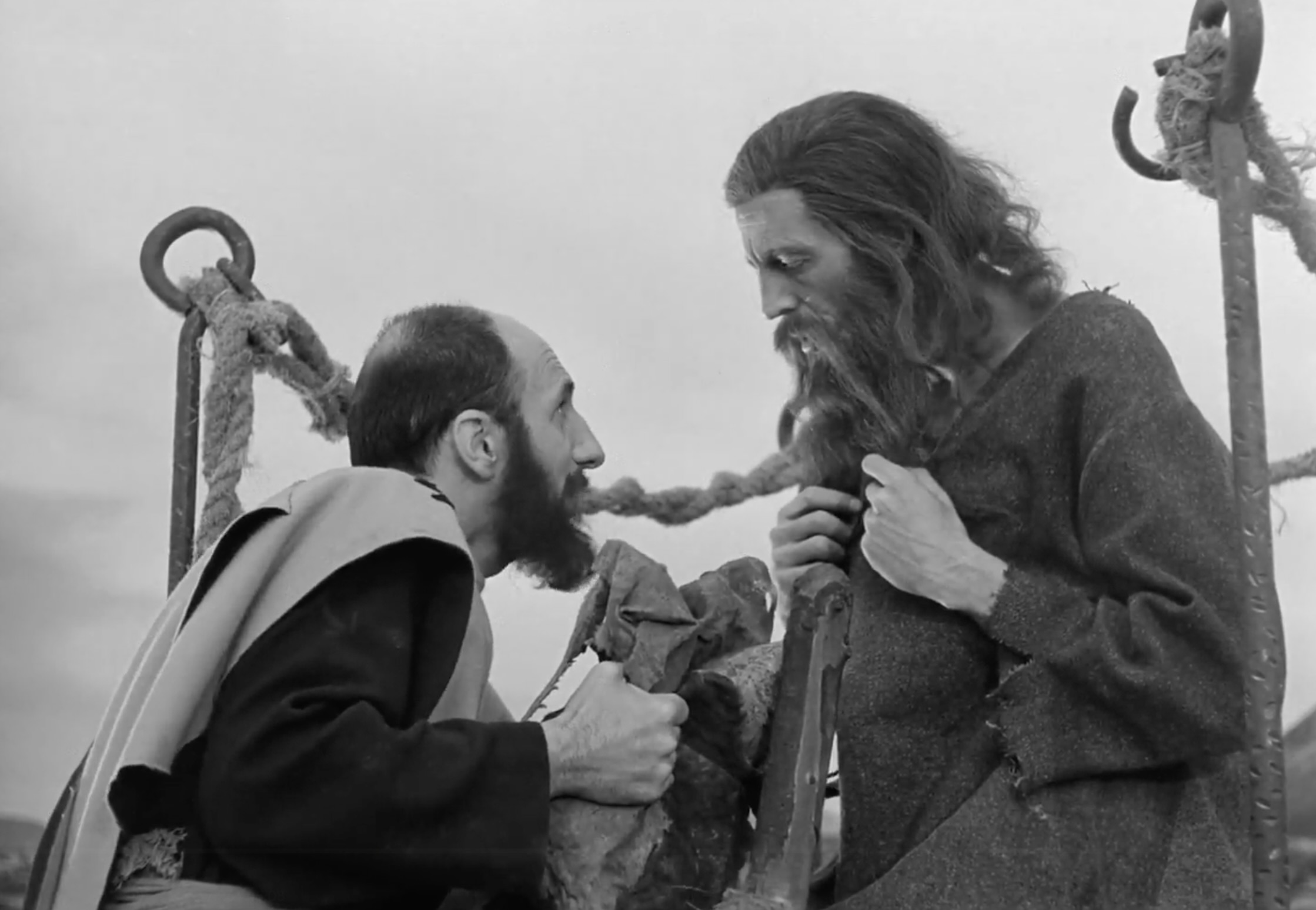 Church member attempting to explain the idea of ownership and greed to Simón using the food bag.