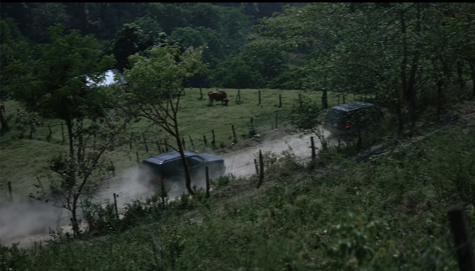 Pickup trucks driving through the village