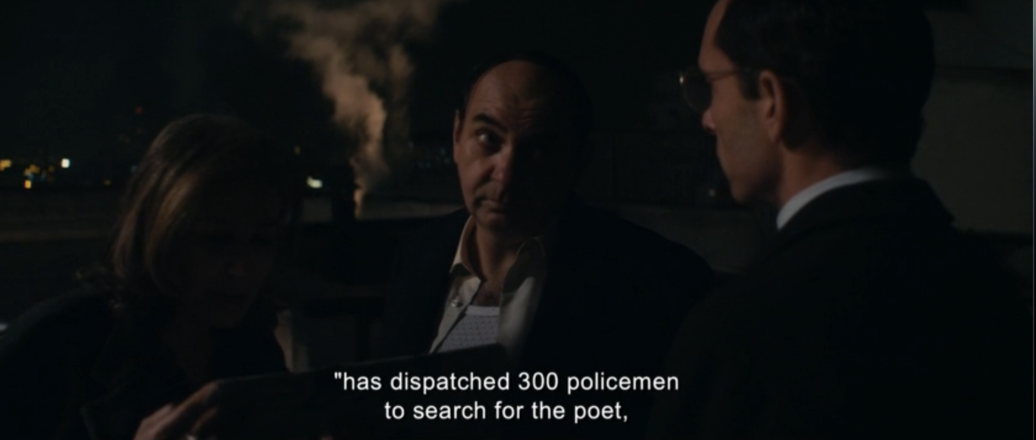 Neruda on a rooftop in Santiago, learning 300 detectives are after him.
