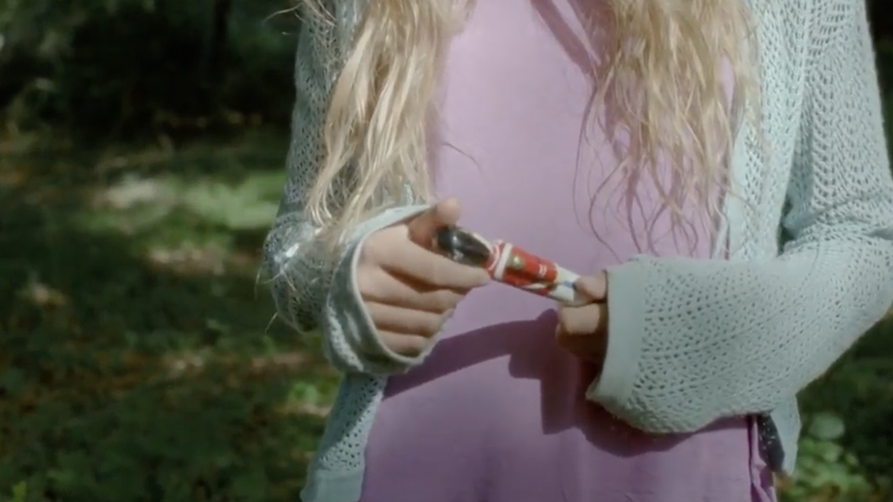 A modern day Inge, fiddles with the toy soldier in her hands. 