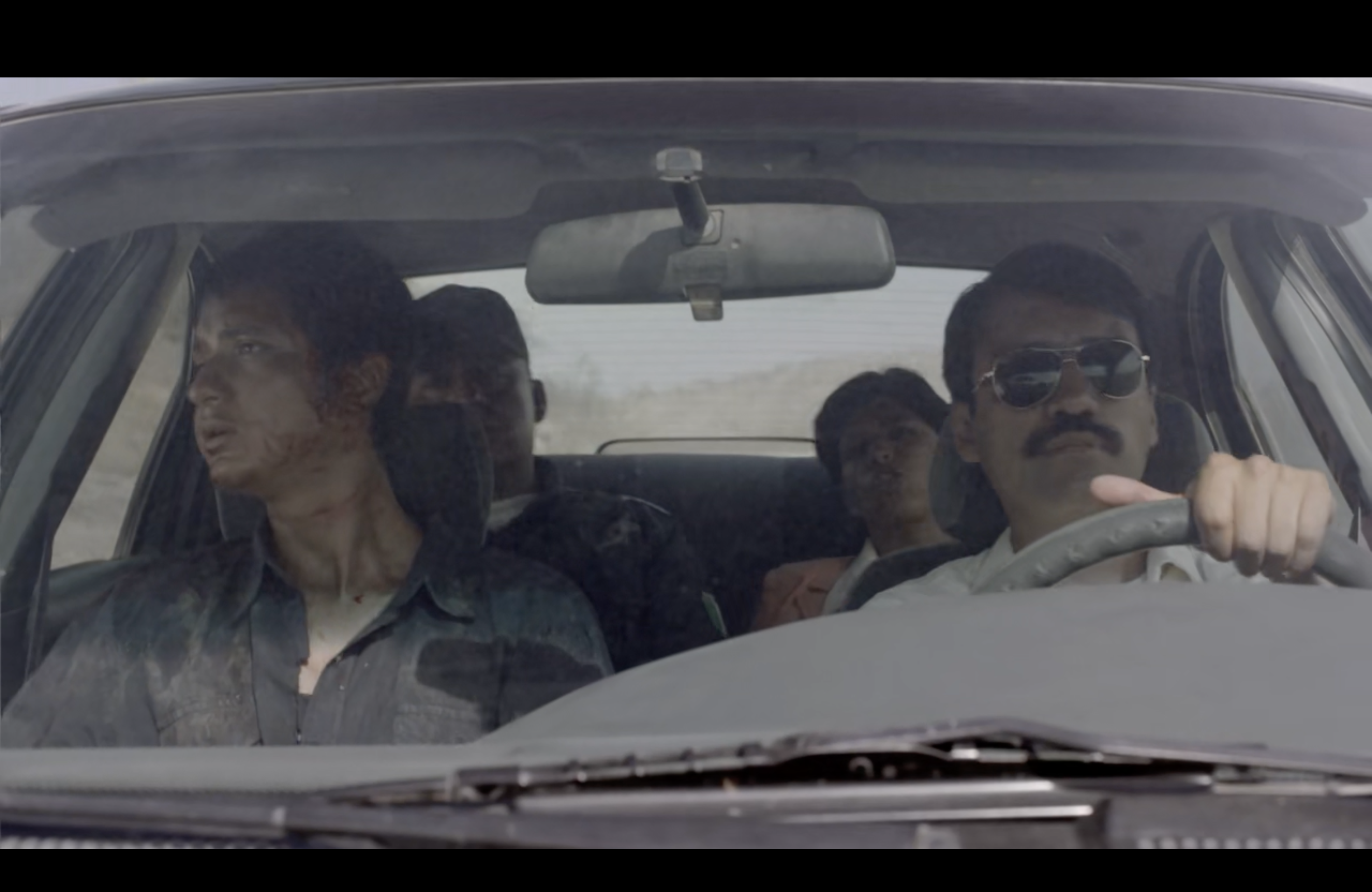 Heli in the car with the investigators 