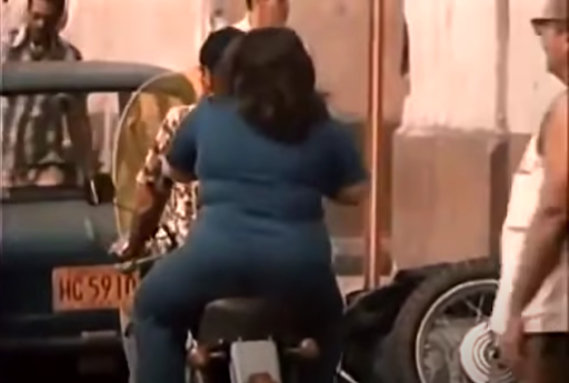 There is a couple on a motorcycle.