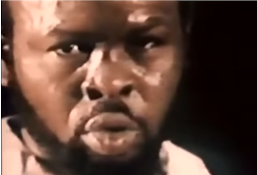 There is a frame of a man talking for the filming of the documentary.