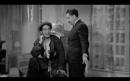Cantinflas puts Don Cayetano's fancier clothes over his simple clothes.