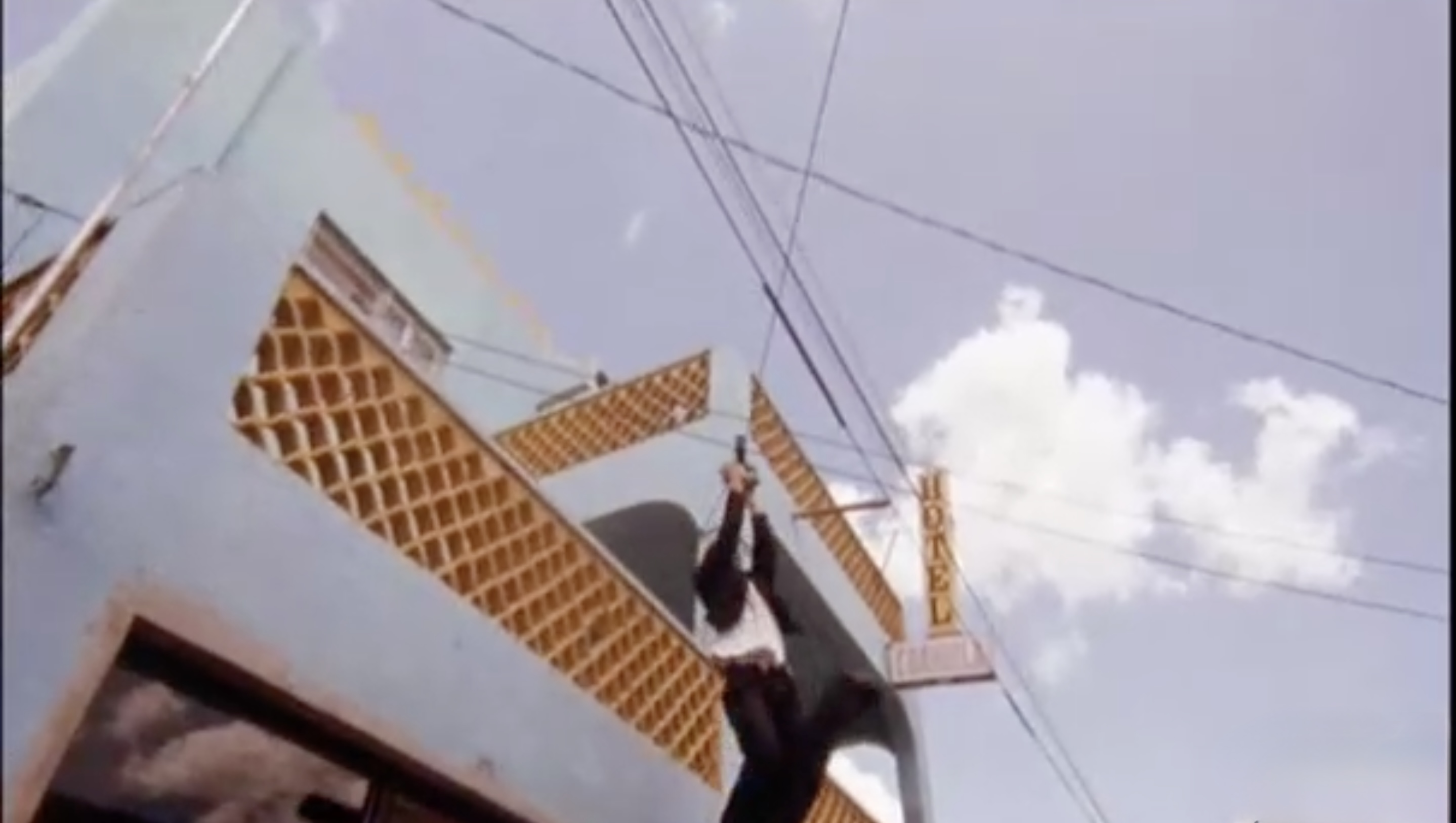 mariachi swinging from a telephone wire