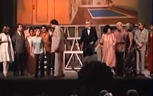 A play is occurring with various actors on stage.