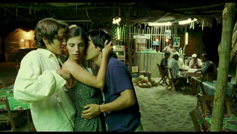Julio, Luisa, and Tenoch dance drunkenly at a bar.
