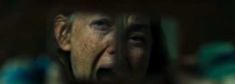 A woman screaming in a broken mirror.