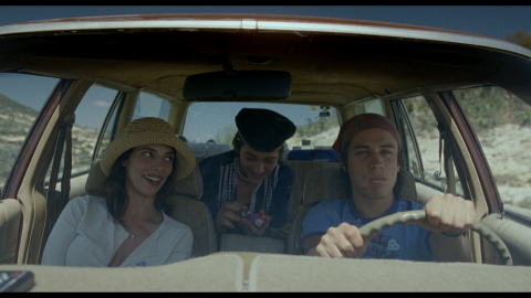 Julio drives, Luisa is seated in the passenger seat, and Tenoch is seated in the back of the car.